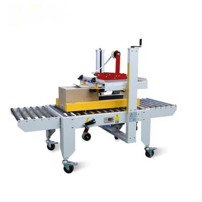 China Hotels Ecommerce Package Box Taping Machine for sale