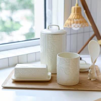 China Multifunctional High Quality White Storage Jar With Lid 3D Ceramic Crafts Embossed Floral Storage Jar Home Decoration for sale