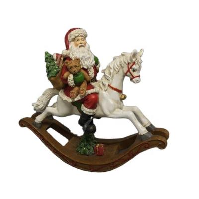 China Europe Resin Christmas Santa On Rocking Horse Decoration Table Ornaments for sale