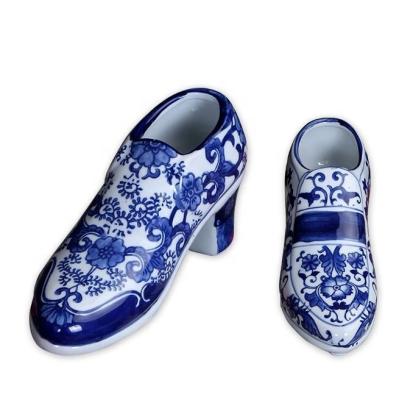 China 2022 stocked/healthy/eco-friendly blue and white ceramic ballerina shoes new design for home decoration high heel shoe vase for sale