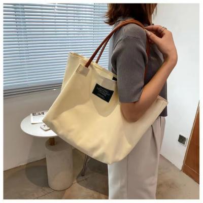 China 2022 High Quality Canvas News Shoulder Bag Luxury Thickened Shoulder Bag Women's Large Capacity University Style Tote Bags for sale