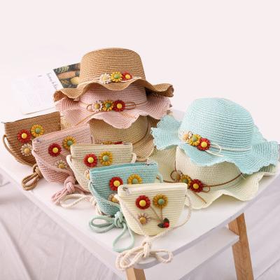 China New Dobby List Straw Hat Handmade Bag Travel Sunscreen Beach Sun Hat Kids Flower Messenger Bag for sale