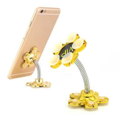 China Adjustable Sucker Stand for Cell Phone 360 degree Rotatable Metal Flower Magic Suction Cup Mobile Phone Holder Car Bracket for sale