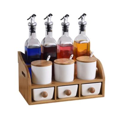 China Flexible condiment set with 4 oil glass condiment sets, 3 ceramic spice jars, 3 ceramic draws, and bamboo stand for sale