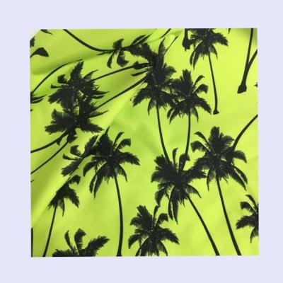 China Green color waterproof coconut tree printing 100%polyester peach skin fabric for men's beachshorts for sale