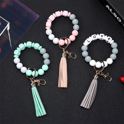 China New Eco-friendly Wooden Bead Wristband Silicone Food Grade Bead Wrist Pendant To Prevent The Loss Of Wristband Keychain for sale