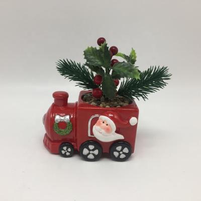 China Christmas Decoration Ceramic Dolomite Christmas Decor Santa Driving Train Head Design With Artificial Flower Pot Plant for sale