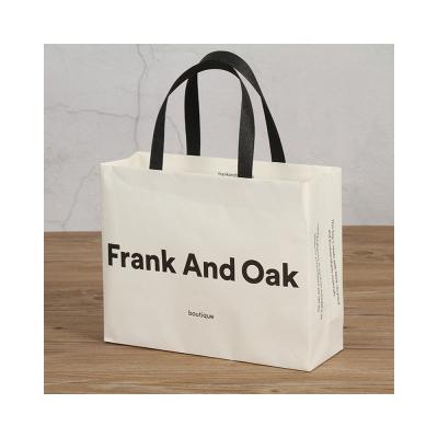 China Clothes wholesale high quality customizable durable paper bag with handle for package clothes for sale