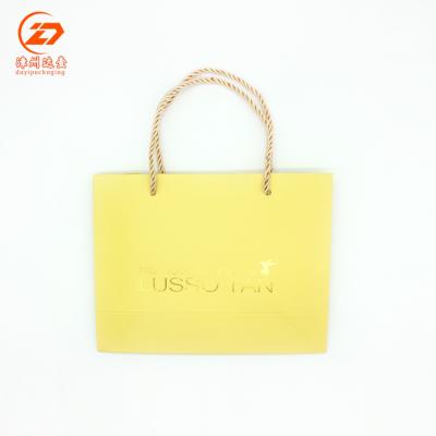 China Recyclable Luxury Printing Logo And Free Design Gold Stamping Yellow Paper Bag for sale