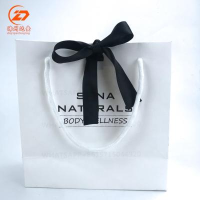 China OEM Recyclable Factory Price Printing Logo Small White Paper Shopping Bag With Ribbon Handle for sale