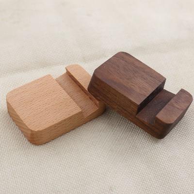 China Adjustable creative custom mini wooden phone stand, solid wood phone stand made of beech/walnut wood for sale