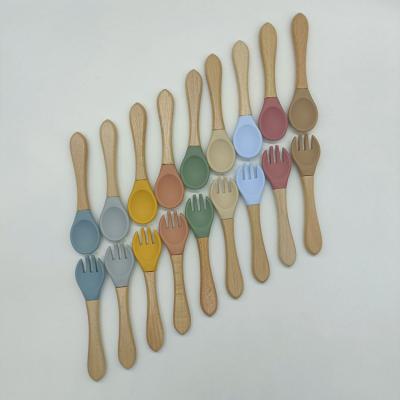 China Viable Wholesale BPA Free Wooden Handle Feeding Soft Silicone Baby Kids Spoon Fork Cutlery Set Tableware for sale