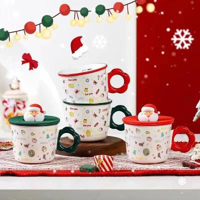 China Christmas Viable Gift Ceramic Mug with 3D Silicone Cover, Big Round Handle Ceramic Mug, Santa Tree Snowman Scale Measuring Mug for sale