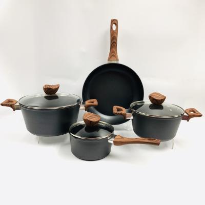 China Sustainable forged aluminum non-stick cookware set with wooden induction bottom transfer handle competitive price kitchen sets cookware sets for sale