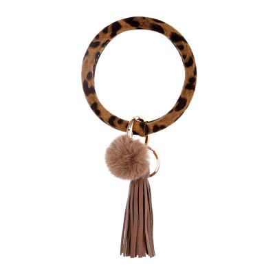 China 2019 Key Rings Women Big Round Keychain Leopard Printed Wristband Key Chain With Fur Ball PU Leather Wrist Keychains for sale