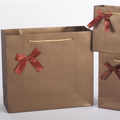 China Recyclable high quality wholesale support custom logo food packaging paper bag with ribbon handle for sale