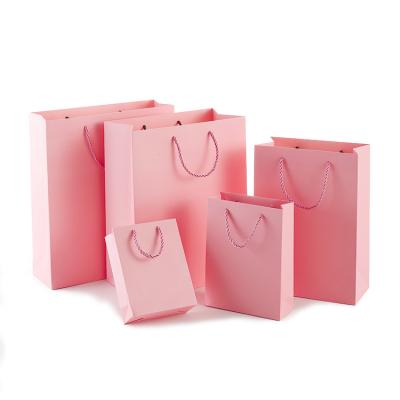 China Handmade Custom Printed Logo Matte Pink Kraft Paper Bag Handbag Shopping Packaging Bag Gift Bag for sale