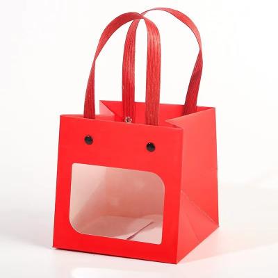 China Luxury Cheap Simple Fancy Gift Bag Red Square Bottom Carry Bag Kraft Paper Gift Portable Handle Bags for sale