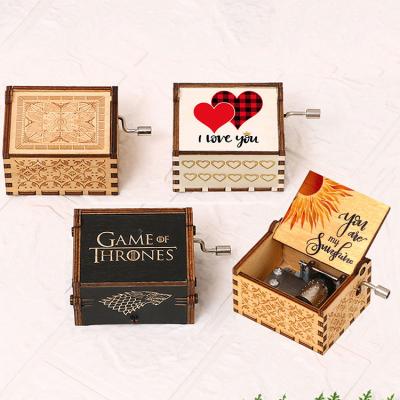 China Europe hot selling mini creative animation operate a variety of music optional wooden hand-cranked music box for sale