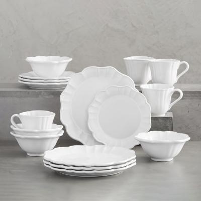 China Promotional European Floral Shape 16 Pcs Dinnerware Style Porcelain Stocked Irregular White Dinner Set With Cups for sale