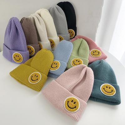 China JOINT Knitted Beanie Hat Women Autumn Winter Fashion Thick Warm Cuff Smiley Face Labeling Couple Hat Students Skull Cap for sale