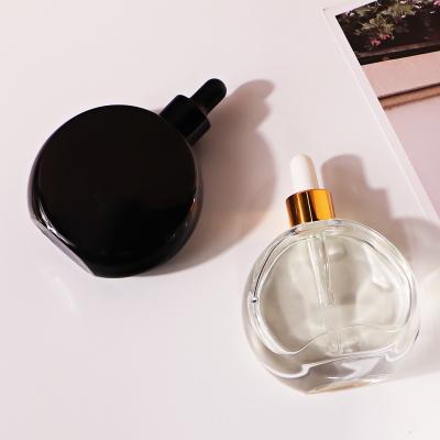 China Lurury 50ml Flat Glass Bottle For Essential Oil Roll On With Black White Screw Lid for sale