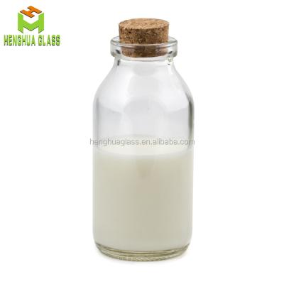 China Mini Milk 120ml Milk Glass Bottle 4oz Round Corked Glass Milk Bottle for sale