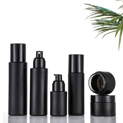 China Matte Black Color 10ml 20ml 30ml 50ml 100ml Personal Care Cosmetic Bottles Frosted Glass Cylinder Lotion Bottle Press Pump Bottle for sale