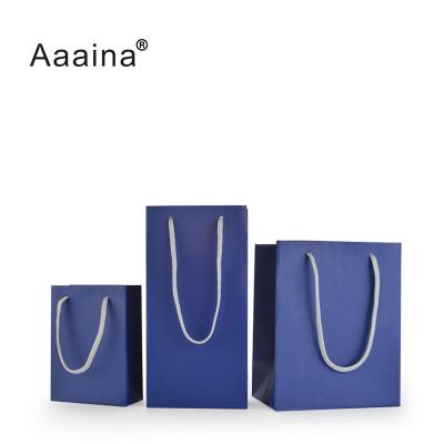 China Recyclable Custom Paper Gift Bags Rope Handle Shopping Paper Packaging Bag With Foil Logo for sale