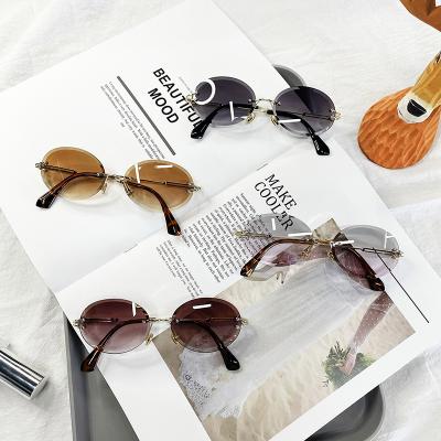 China 2021 Crystal Texture Oval Designer Promotion Oval Shade Sun Glasses Sun Glasses Rimless Metal Frame Shade UV400 for sale