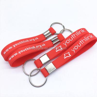 China Personalized printed silicone wristband with keychain, fully customized silicone key chain with your logo or text for sale