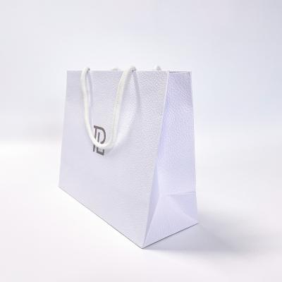 China Luxury White Recyclable Custom Logo Card Panel Art Paper Bag Cardboard Paper Gift Bag With Handles for sale