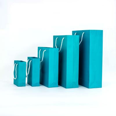 China Recycled Materials Logo Size Customizable Fashion Gift Shopping Bags Waterproof Blue Standing Paper Kraft Bags With Handle for sale