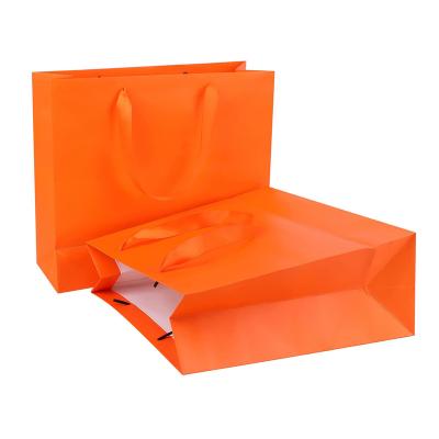 China Recycled Materials Factory Low Price Direct Selling Flower Gift Jewelry Shopping Bag The Orange Paper Tote Bags With Custom Logo for sale