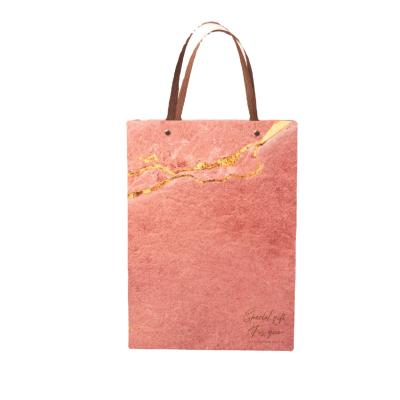 China Biodegradable rivet processing fashionable gift handmade bag pattern decoration high-end marble paper bags and simple packaging for sale