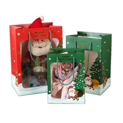 China Recycled Materials Christmas Shopping Bags With Elegant Santa Claus Snowflake Embossing Transparent Window Gift Package Bag for sale