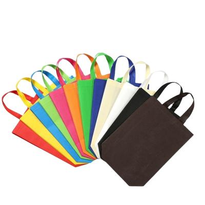 China Recyclable Nonwoven Bag Rainbow Colors Party Bags Handle Non Woven Goodie Bottom Bag With Handles for sale