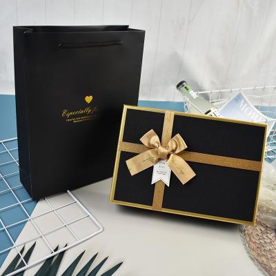 China Recycled Materials Paper Gift Box Square Shaped Flower Gold Bowknot Packaging Packaging Box With Custom Logo for sale