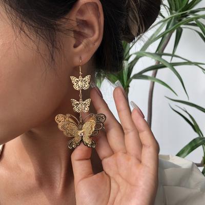 China FASHIONABLE Hollow Butterfly Metal Cutout Hanging Earrings Young Girls Bridesmaids Long Butterfly Earrings for sale