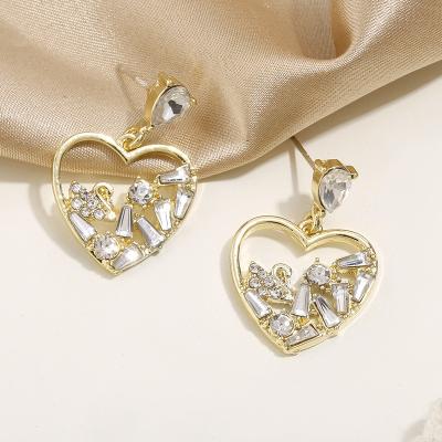 China FASHIONABLE Heart Shaped Embossed Stud Earrings Gold Plated Hollow Out Crystal Heart Drop Earings for sale