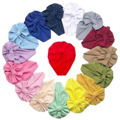 China Sports Cloth Hood Baby Infant Beanie Solid Color Hats Girl Sweater Hat Bows Knot Soft Protective Newborn Hat for sale