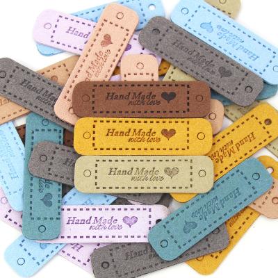 China Sustainable Crafts Sewing Handmade Label 56x15MM Hand Made With Love Tags Leather Labels For Clothes for sale