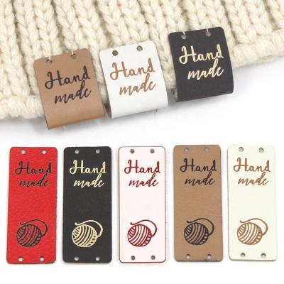 China Sustainable Hand Made Label For Hats Knitted Yarn PU Ball Leather Tags For Clothes Handmade Label for sale