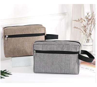 China Multifunctional Waterproof Cationic Fabric Cosmetic Bag Large Capacity Handle Travel Storage Makeup Bag for sale