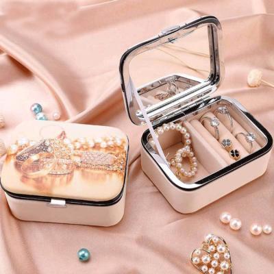 China Portable Jewelry Organizer Northern Europe PU Jewelry Box Leather Color Print Storage Box With Mirror Travel Custom Small Jewelry Box for sale