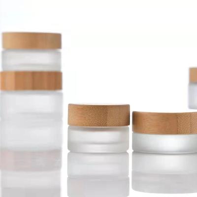 China High Quality Thick Clear Glass Cosmetic Jars Skin Care Cosmetic Packaging China Storage Spice Jar With Real Bamboo Wooden Lids for sale