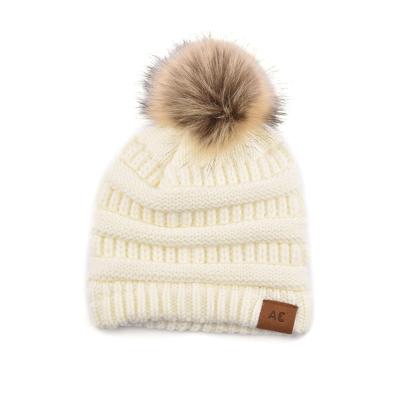 China JOINT Cable Fashion Knit Beanie Custom Real Fur Pompoms Knitted Hats Women Ski Winter Hats for sale