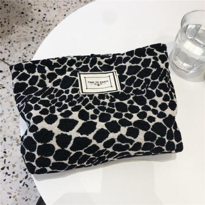 China 100% Custom Logos Eco-friendly Leopard Print Zebra Large Capacity White And Black Canvas Coated Cosmetic Bag For Women for sale