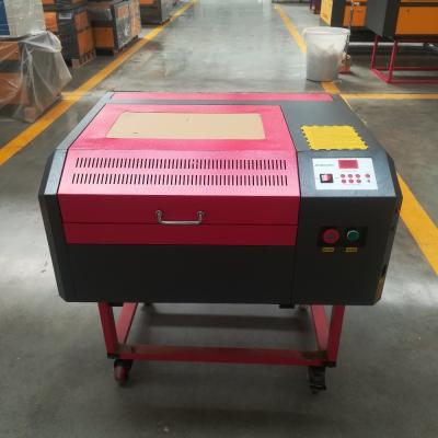 China RUIDA control 50W 4040 laser engraving and cutting machine with red point and honeycomb for sale