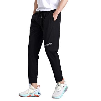 China Custom Wholesale Loose Slim Fitness Anti-Wrinkle Stretch Mid Waist Jogging Pants For Men for sale